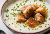 Velvety Roasted Garlic Potato Soup with Crispy Grilled Cheese Croutons