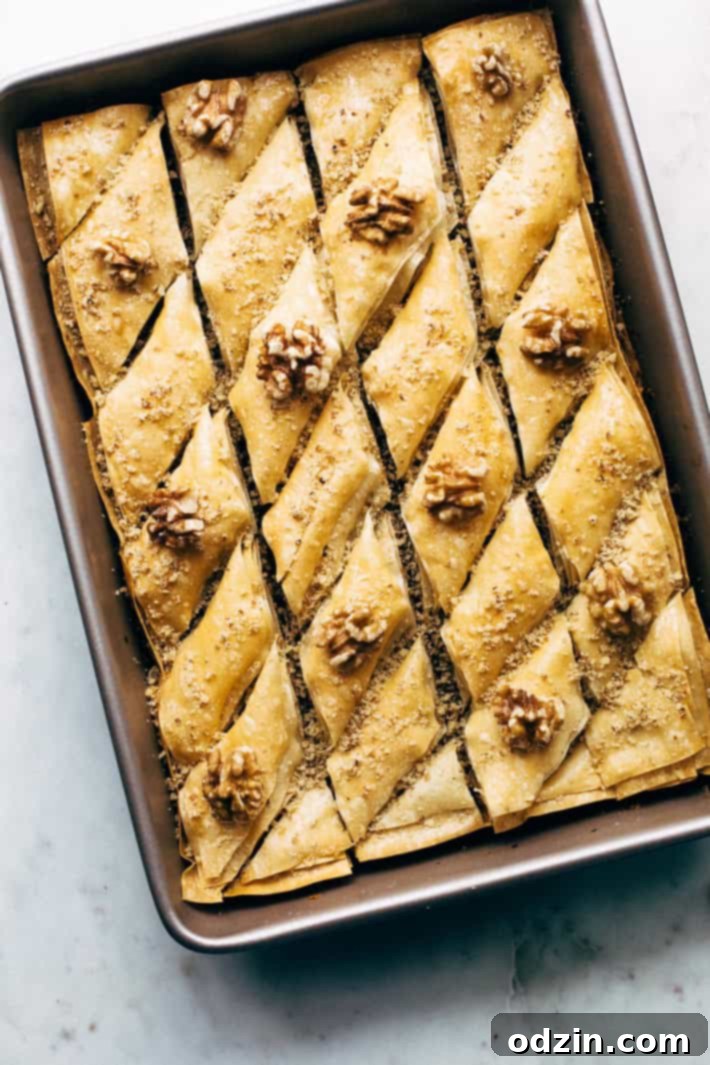 Holiday Walnut Baklava - buttery phyllo with layers of ground walnuts in between and drizzled with a homemade simple syrup with sweet orange blossom and rose water! So good! #baklava #walnutbaklava #lebanesebaklava | Littlespicejar.com