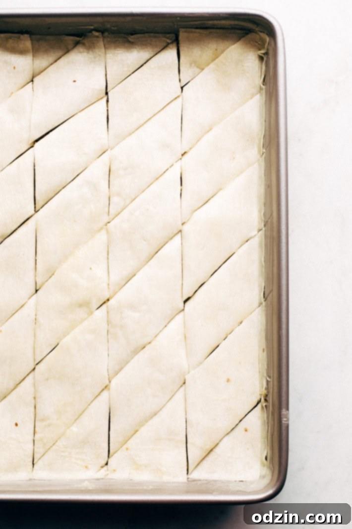 Holiday Walnut Baklava - buttery phyllo with layers of ground walnuts in between and drizzled with a homemade simple syrup with sweet orange blossom and rose water! So good! #baklava #walnutbaklava #lebanesebaklava | Littlespicejar.com