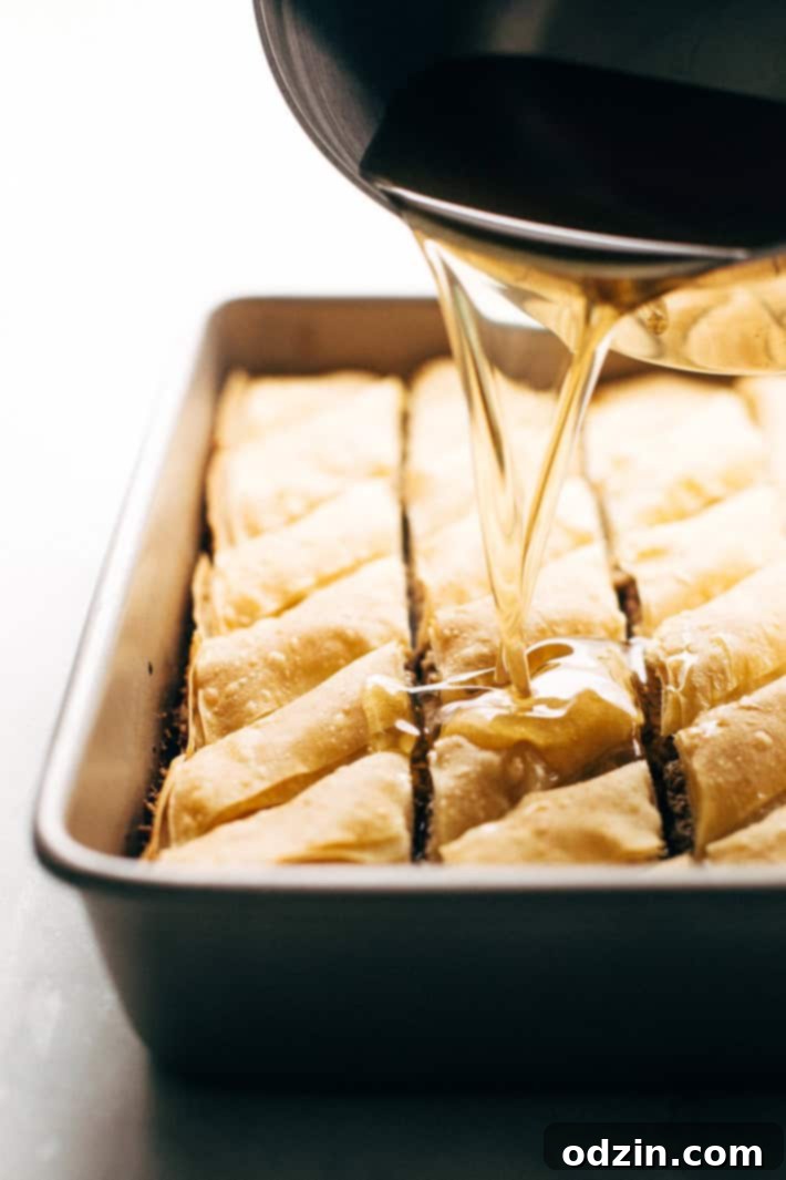 Holiday Walnut Baklava - buttery phyllo with layers of ground walnuts in between and drizzled with a homemade simple syrup with sweet orange blossom and rose water! So good! #baklava #walnutbaklava #lebanesebaklava | Littlespicejar.com