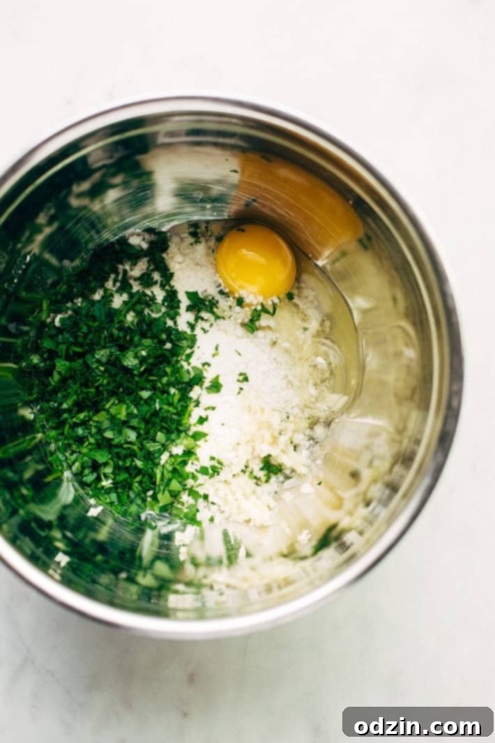 Cheesy Stuffed Meatballs in Homemade Tomato Sauce - The perfect meal for spaghetti and meatball night! Or serve them as party appetizers for New Years, Christmas, and Super Bowl parties! #stuffedmeatballs #cheesestuffedmeatballs #homemadetomatosauce | Littlespicejar.com