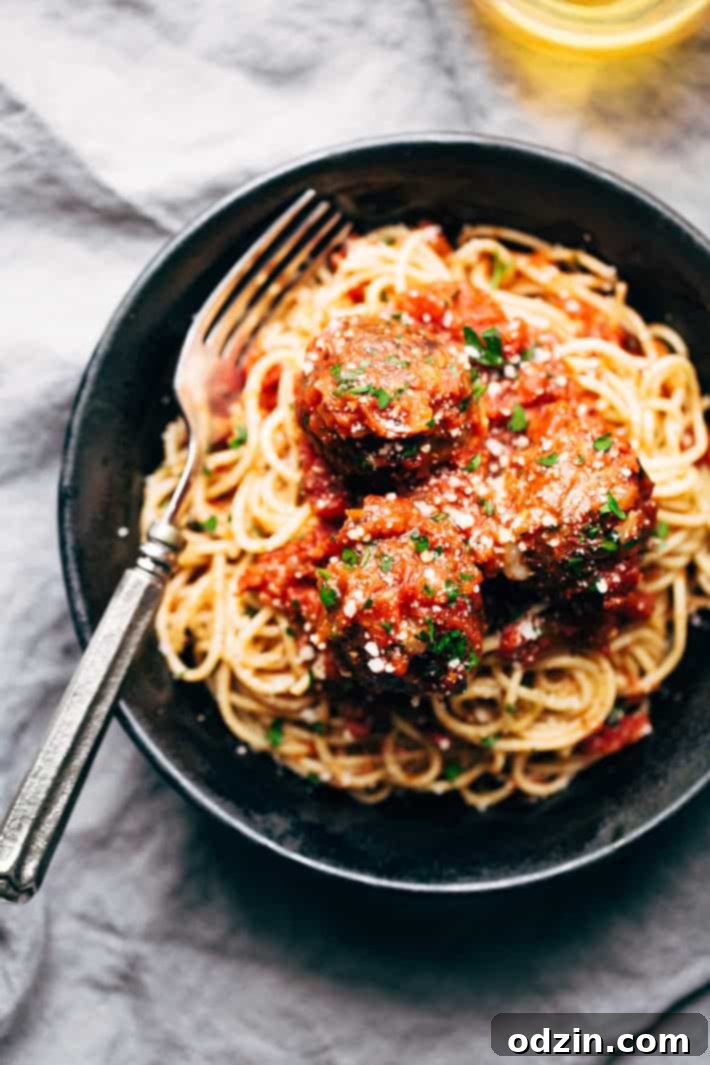 Cheesy Stuffed Meatballs in Homemade Tomato Sauce - The perfect meal for spaghetti and meatball night! Or serve them as party appetizers for New Years, Christmas, and Super Bowl parties! #stuffedmeatballs #cheesestuffedmeatballs #homemadetomatosauce | Littlespicejar.com