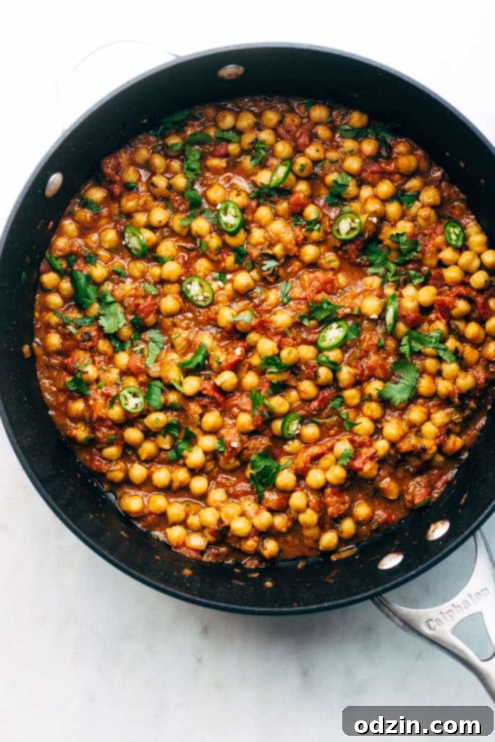Weeknight Chana Masala Rice Bowls - A quick weeknight take on the traditional Chana Masala! Serve over basmati rice and it's the perfect warm and cozy winter meal! #chanamasala #indianfood #chana #vegan | Littlespicejar.com