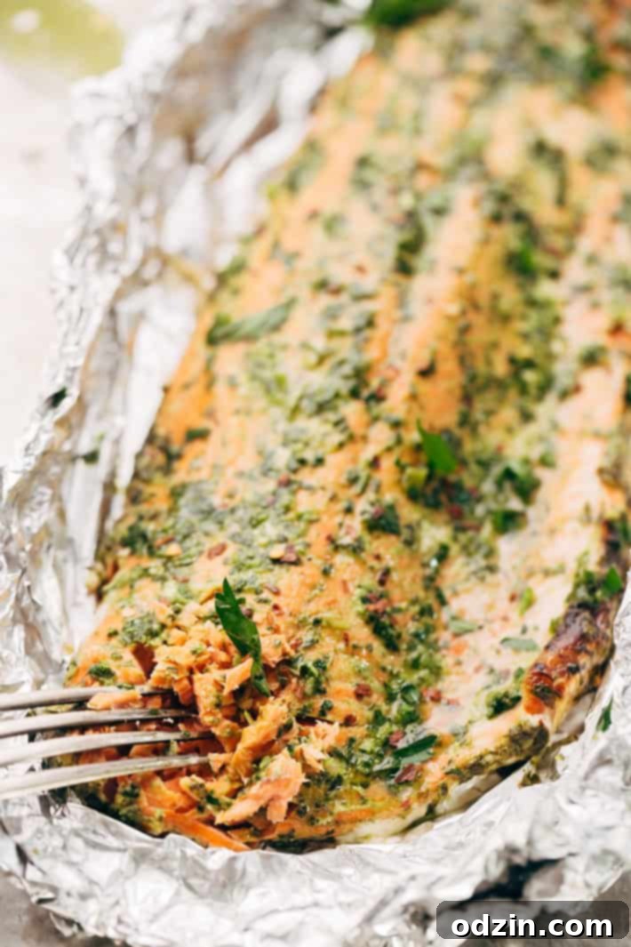 Super Easy Baked Salmon in Foil with Chimichurri Sauce - An easy recipe that takes less than 30 minute to make and is perfect for using on salads or serving with roasted veggies! #bakedsalmon #salmoninfoil #chimichurrisalmon | Littlespicejar.com