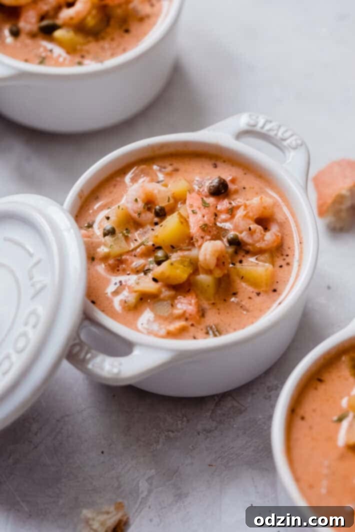 staub ceramic bowl with lid filled with salmon chowder