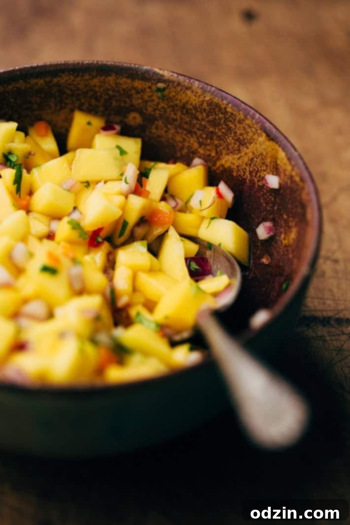 Tropical Mojo Chicken Quinoa Bowls with Mango Salsa and Black Beans 6 Seared Mojo chicken pieces cooking in a hot skillet