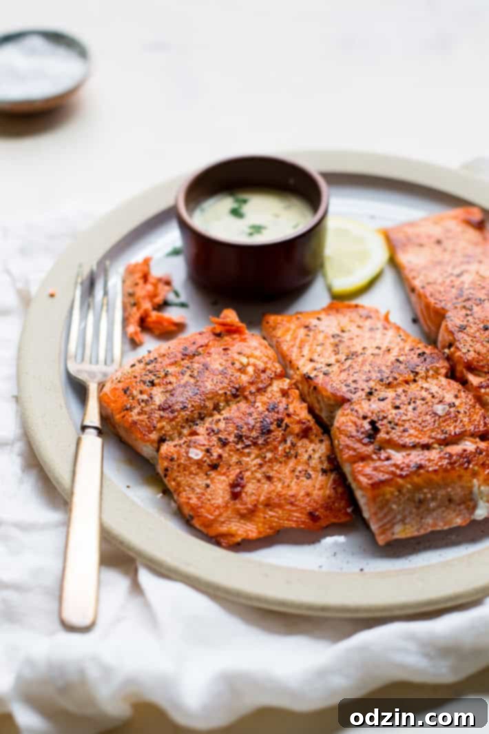 Close-up of flaky, moist pan-seared salmon with a golden crust.
