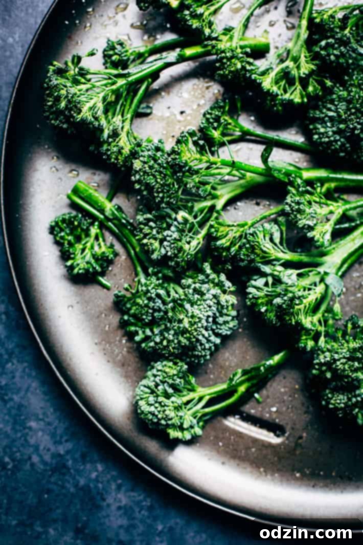 A close-up of a serving of pan-seared salmon, generously drizzled with the creamy lemon sauce.