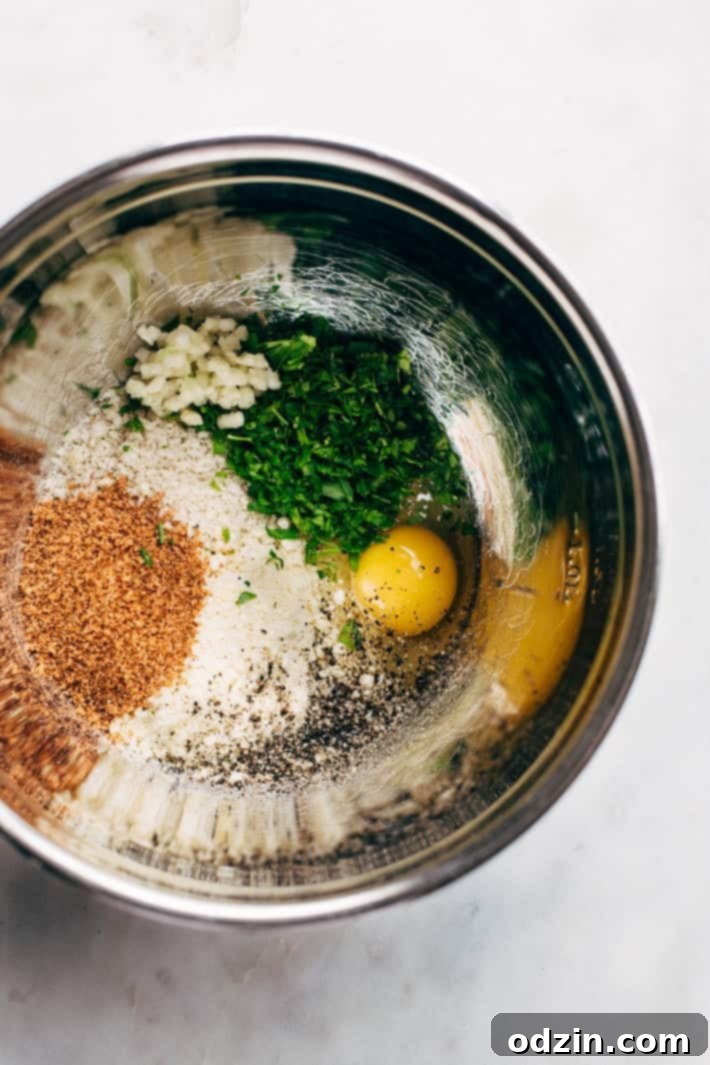 Cajun Chicken Meatballs in Tasty Cream Sauce - A view of the meatballs cooking in the flavorful, creamy sauce. Cajun Chicken Meatballs simmering in a rich, creamy sauce with sautéed vegetables like onions, bell peppers, and mushrooms.