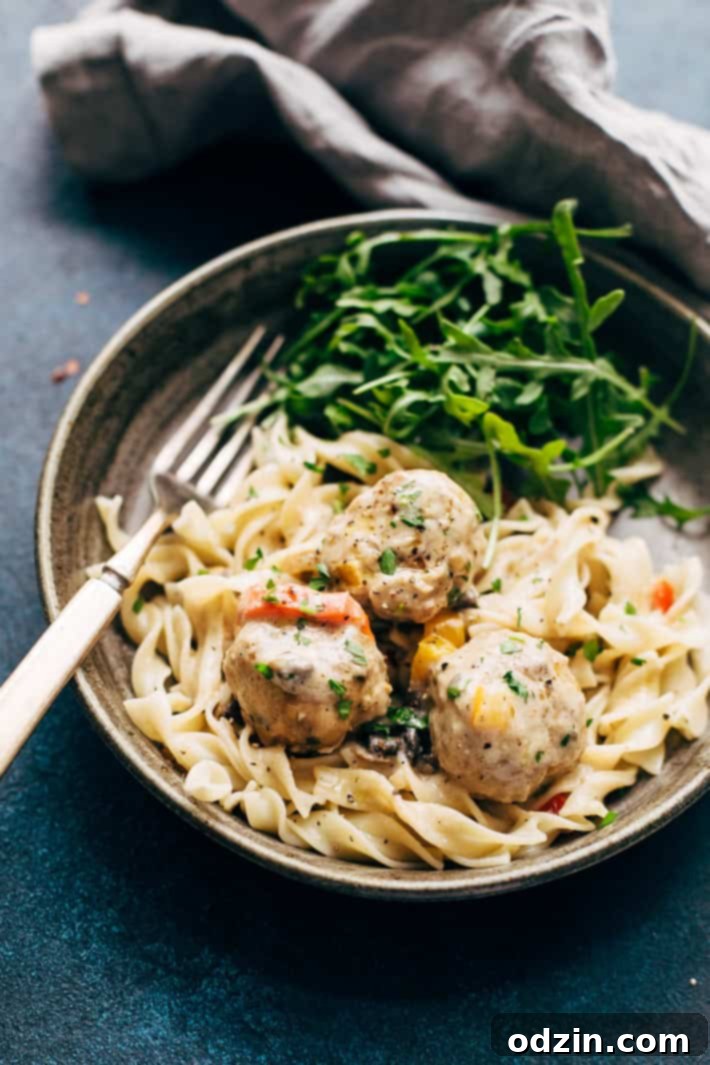 Cajun Chicken Meatballs in Tasty Cream Sauce - A delightful and comforting meal featuring tender chicken meatballs in a savory cream sauce. A serving of Cajun Chicken Meatballs in Tasty Cream Sauce, garnished with fresh basil, ready to be enjoyed as a hearty dinner.