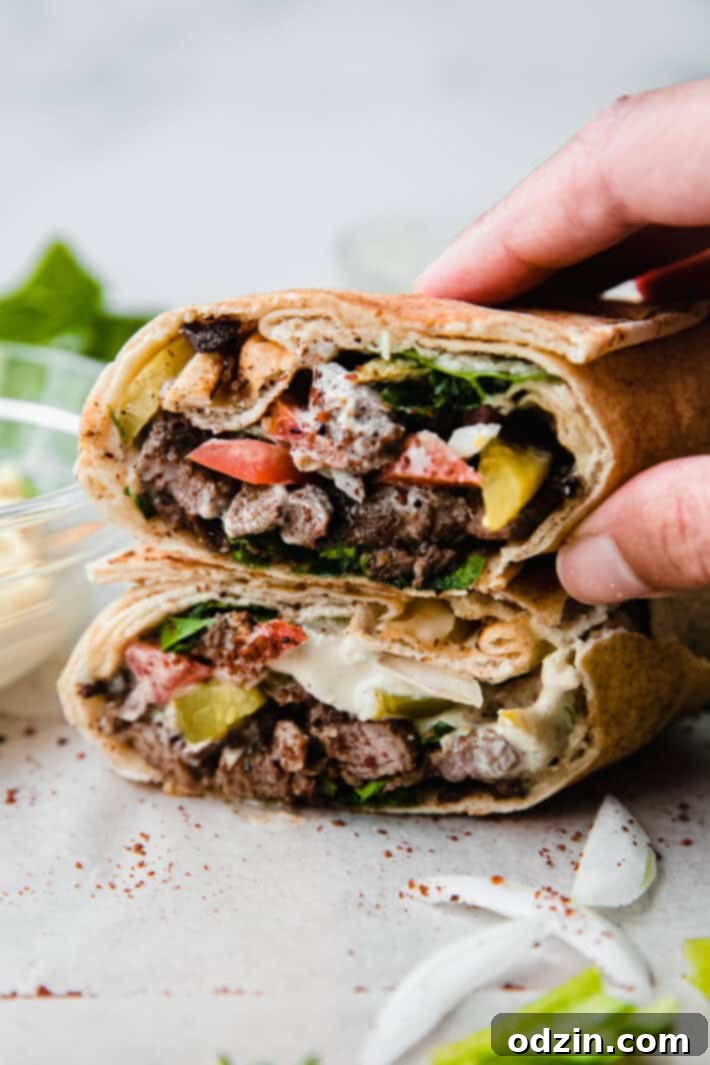 Stacked beef shawarma meat ready for serving on parchment paper