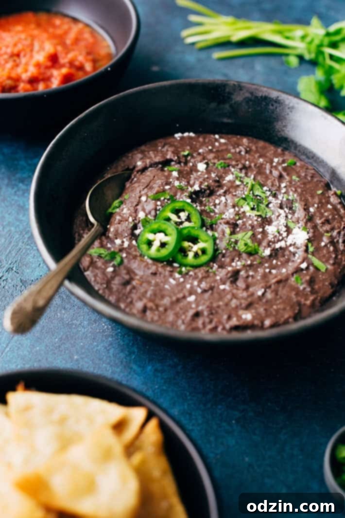 Easy No-Soak Refried Black Beans Homemade Instant Pot refried black beans in a bowl, ready to serve