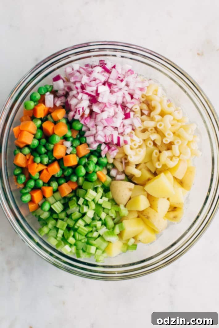 Mashup Macaroni Potato Salad - my family's favorite potato salad recipe! This is easy to make and is LOADED with flavor! #potatosalad #salad #macaronisalad #picnic #barbecue | Littlespicejar.com Bowl of Macaroni Potato Salad ready to be served, highlighting the fresh ingredients and creamy dressing. Great for outdoor entertaining. #potatosalad #salad #macaronisalad #picnic #barbecue #homemade