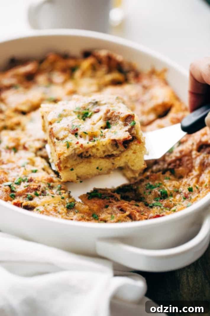 Close-up of the Sun-dried Tomato Basil Breakfast Casserole showing its golden crust and melted cheese.