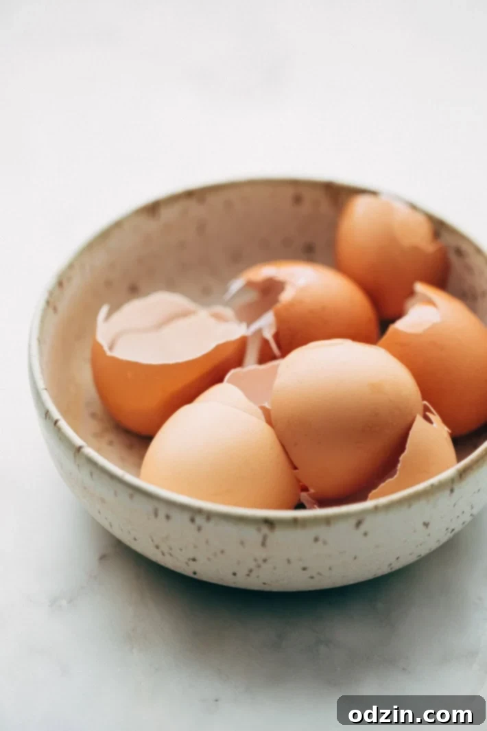 Close-up of the casserole layers before baking, showing diced bread, sun-dried tomatoes, and cheese.