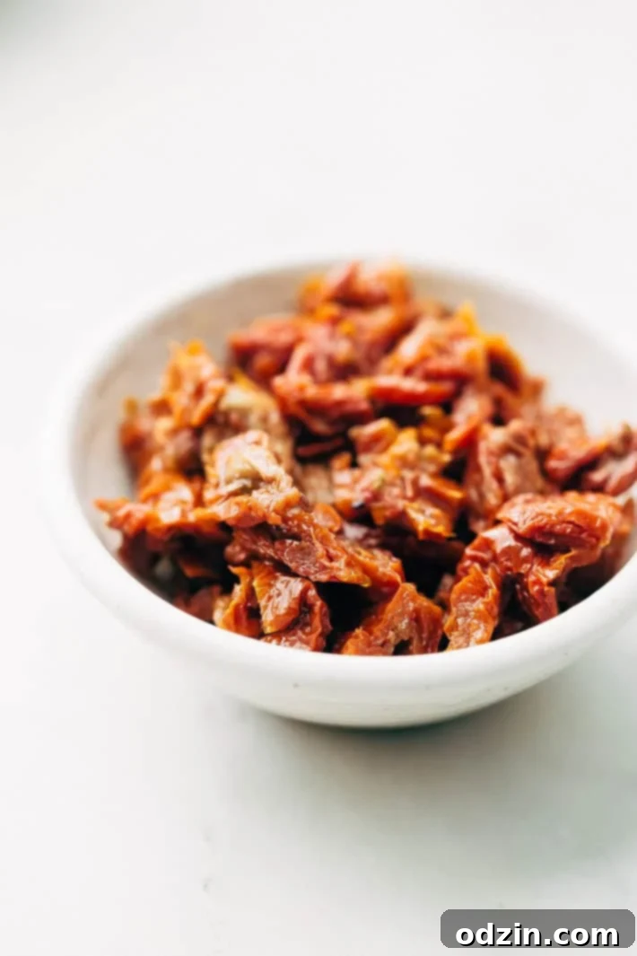 The egg and milk mixture being poured over the bread and cheese in the casserole dish.
