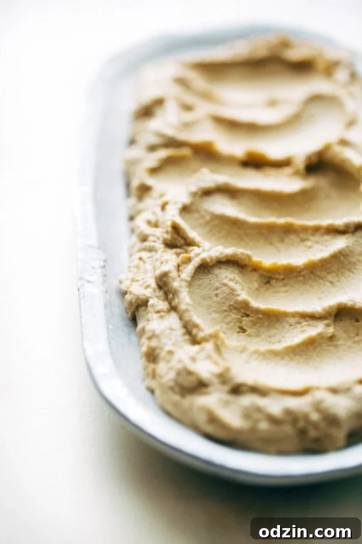 Seven Layer Chickpea Shawarma Dip being assembled