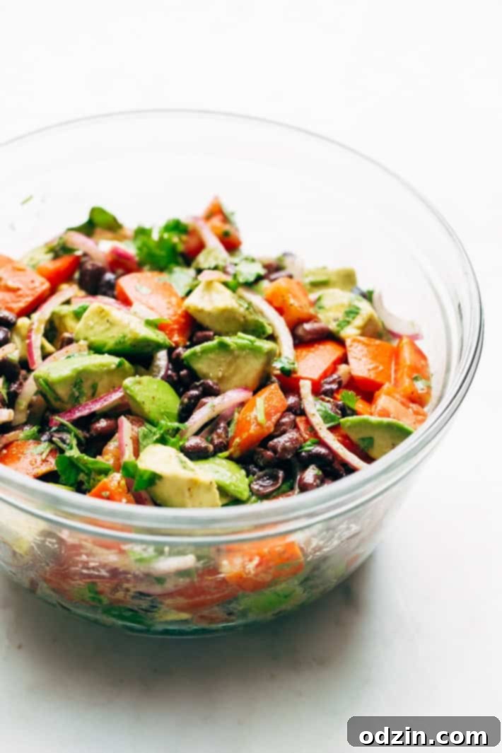 Delicious Black Bean Tomato Avocado Salad brimming with fresh ingredients, a healthy and easy guacamole-inspired meal. Perfect for lunch or a side dish. #avocado #avocadosalad #blackbeansalad