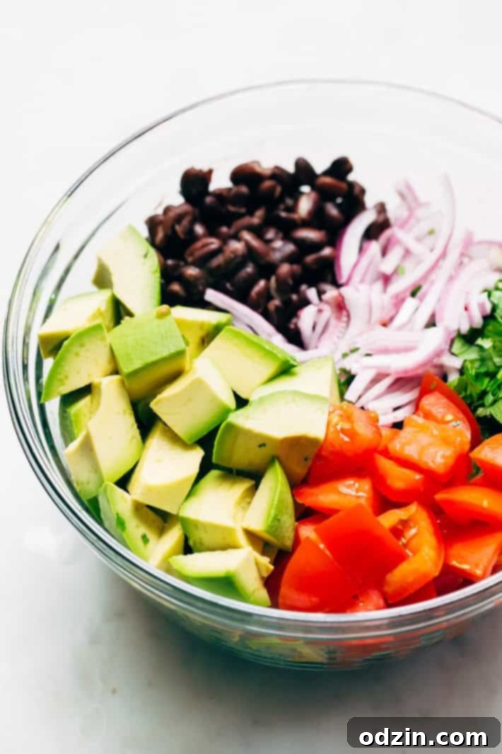 Overhead shot of the Black Bean Tomato Avocado Salad, illustrating the simple yet impactful combination of ingredients. Ideal for a light lunch or a robust side dish. #avocado #avocadosalad #tomatoavocadosalad #blackbeansalad