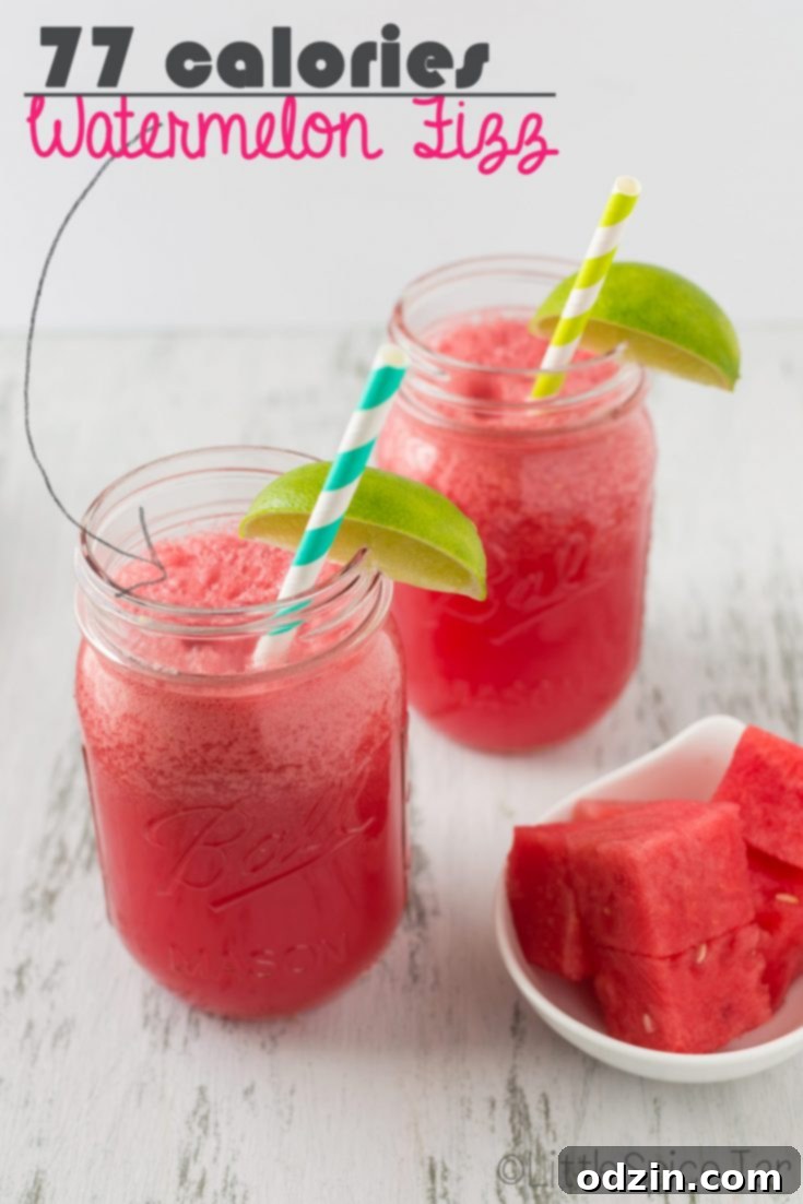 Delicious Watermelon Fizz garnished with a lime slice and a fresh mint sprig.