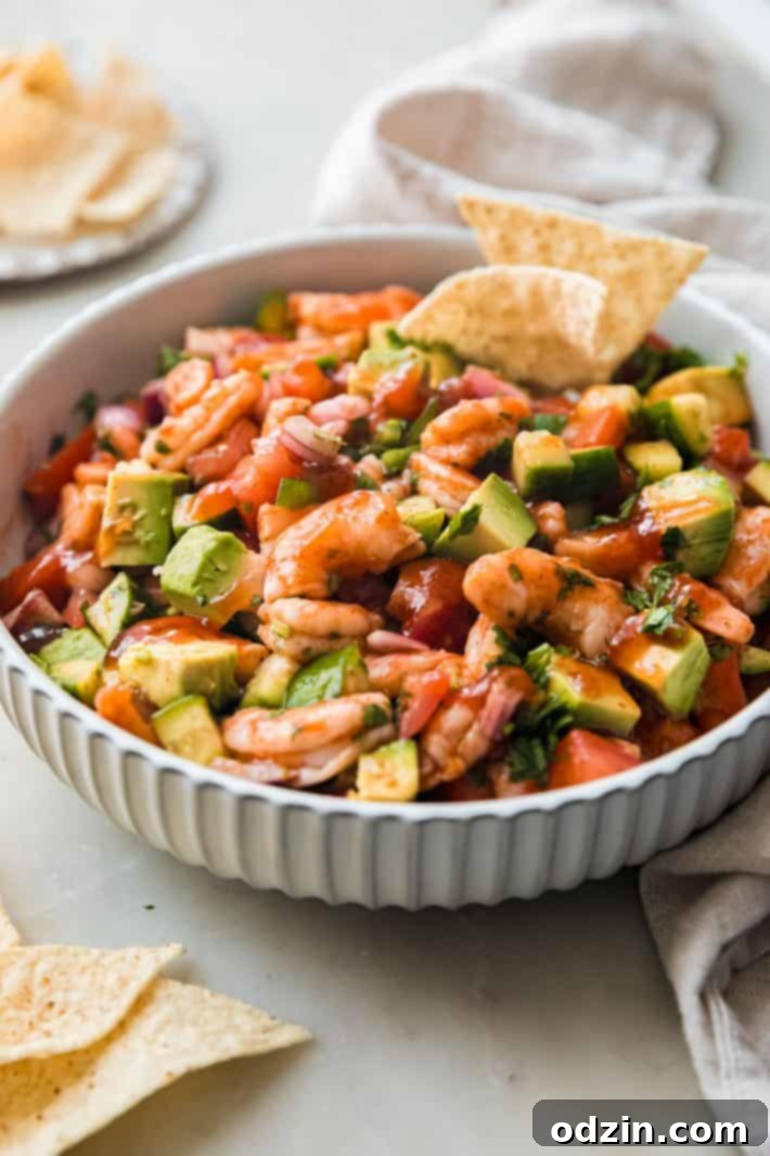 Fresh Mexican Shrimp Cocktail stuffed into ripe avocado halves, garnished with cilantro, served with tortilla chips.