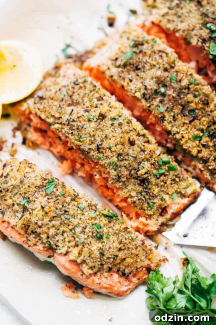 lemon pepper baked salmon fillet on a spatula, showcasing its crisp topping