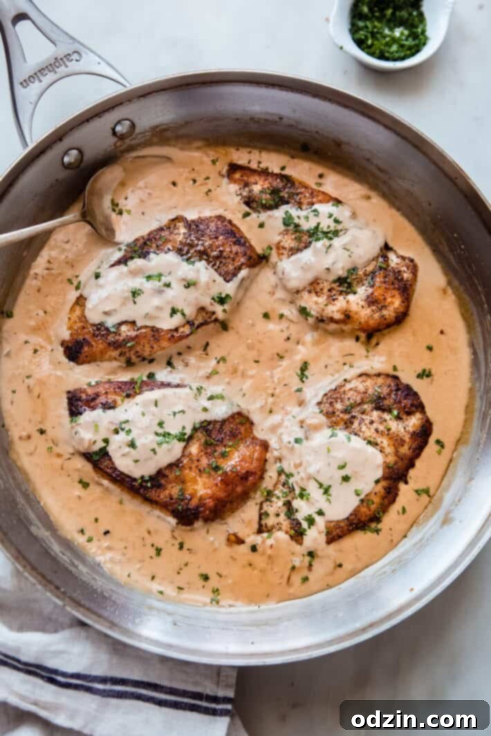skillet with balsamic chicken on white marble