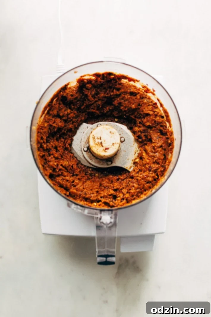 Homemade Thai Massaman Curry Paste - A quick 15 minute paste that's perfect to use in all kinds of curries! This can also be made vegan/vegetarian friendly. #massamancurry #homemadecurrypaste #thaicurry #massamancurrypaste | Littlespicejar.com A selection of fresh ingredients like guajillo peppers, ginger, and shallots, key components for the accessible Massaman curry paste recipe.