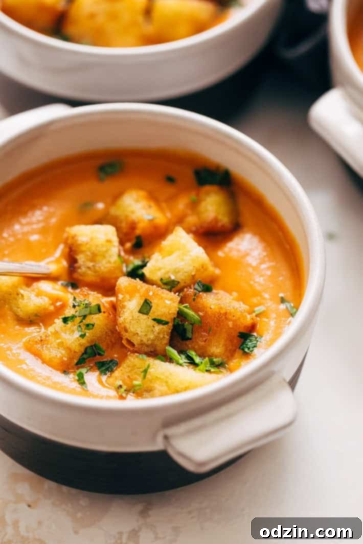 Vibrant orange butternut squash soup simmering in an Instant Pot, showing the cooking process.
