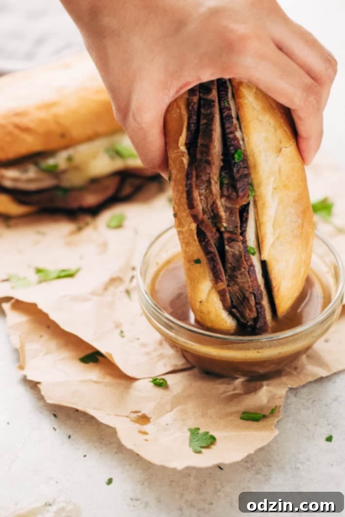 A close-up showing the tender, shredded beef from the slow cooker, ready to be assembled into sandwiches.