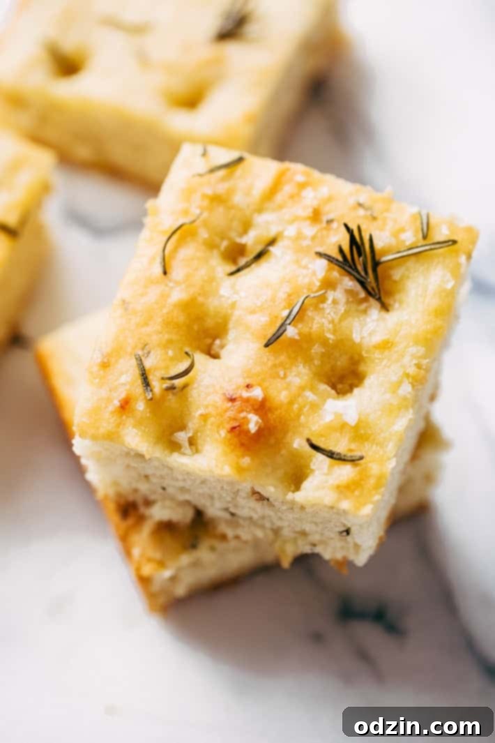 stack of roasted garlic rosemary focaccia bread with Maldon salt on top