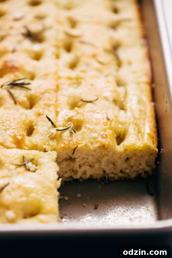 side shot of focaccia in baking pan to show inside texture
