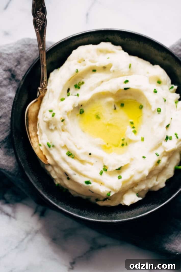 mashed potatoes with butter pool and chives in black plate
