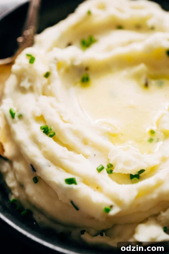 close up of fluffy mashed potatoes with chives on top