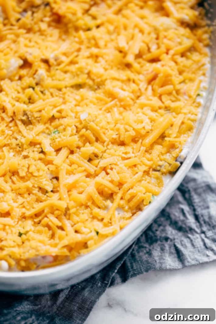 Sauteing Mushrooms for Chicken Pot Tater Tot Hotdish - Butter crackling in a dutch oven with sliced mushrooms beginning to brown, a crucial step for developing flavor.