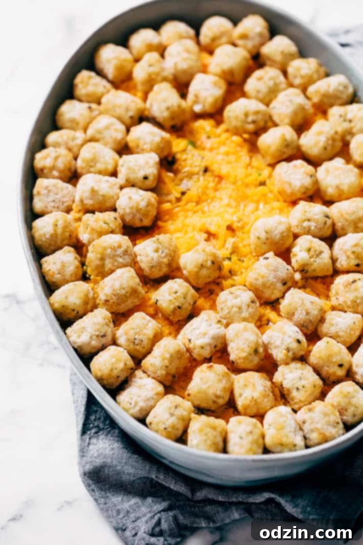 Adding Flour and Seasoning to Chicken Pot Hotdish Base - A pan with sautéed vegetables, flour, and spices being stirred, creating a roux for the rich, creamy sauce.