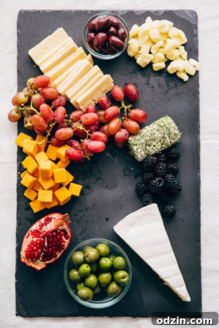 How to make an EPIC Holiday Cheese Board - Learn step-by-step how to put together the best cheese board your guests have seen! #holidaycheeseboard #cheeseboard #cheeseplatter #cheeseplate #cheeseandfruitplate | Littlespicejar.com
