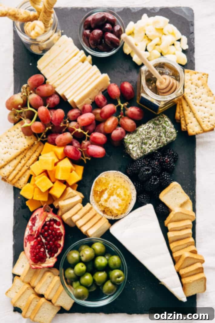 How to make an EPIC Holiday Cheese Board - Learn step-by-step how to put together the best cheese board your guests have seen! #holidaycheeseboard #cheeseboard #cheeseplatter #cheeseplate #cheeseandfruitplate | Littlespicejar.com