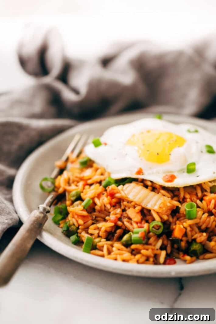 Simple and Delicious Kimchi Fried Rice Another perspective of a bowl of kimchi fried rice, showing its texture and rich color.