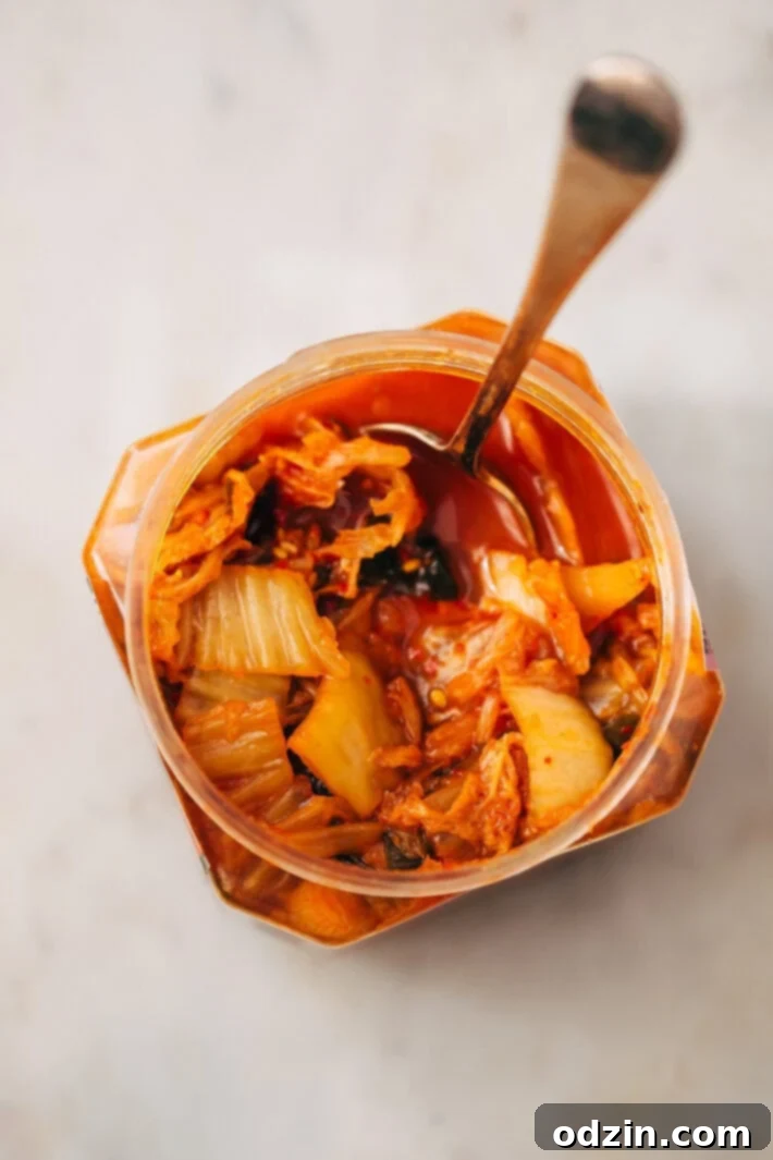 Fresh Kimchi Ready for Cooking Raw kimchi in a bowl, showing its texture and vibrant red color before being cooked.