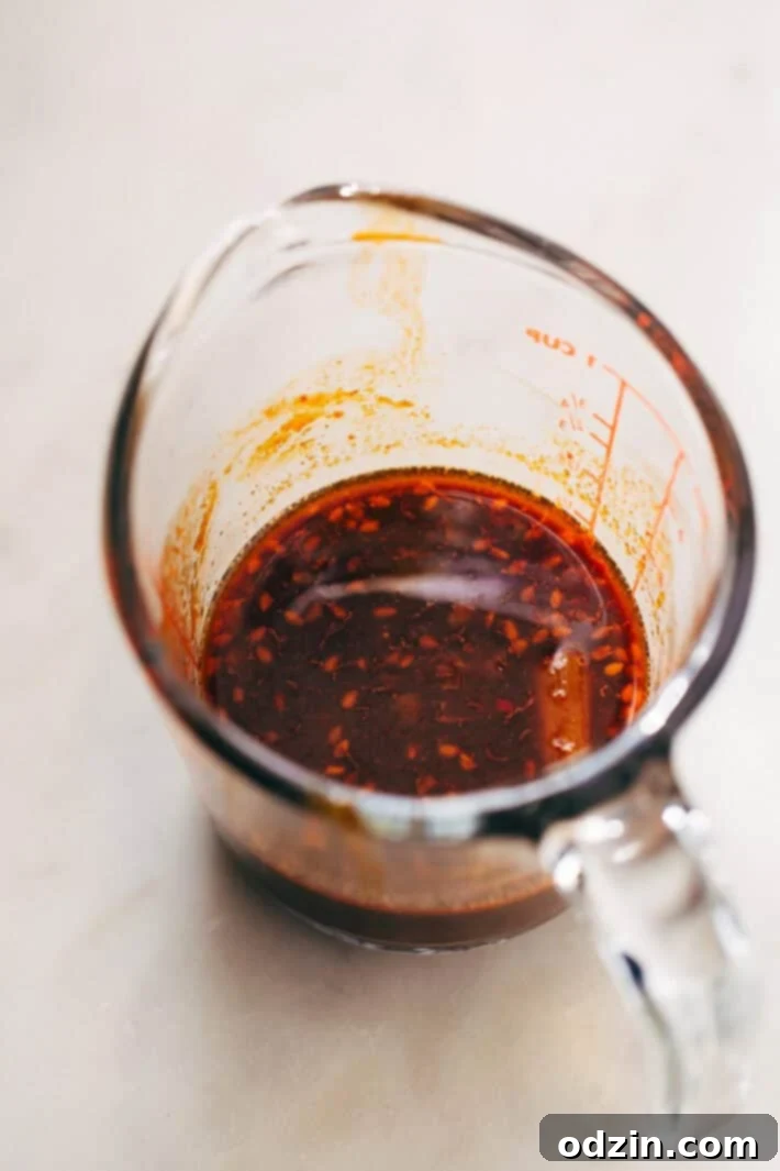 Prepped Ingredients for Kimchi Fried Rice Ingredients for kimchi fried rice laid out: chopped kimchi, onions, peas, carrots, and sauces.
