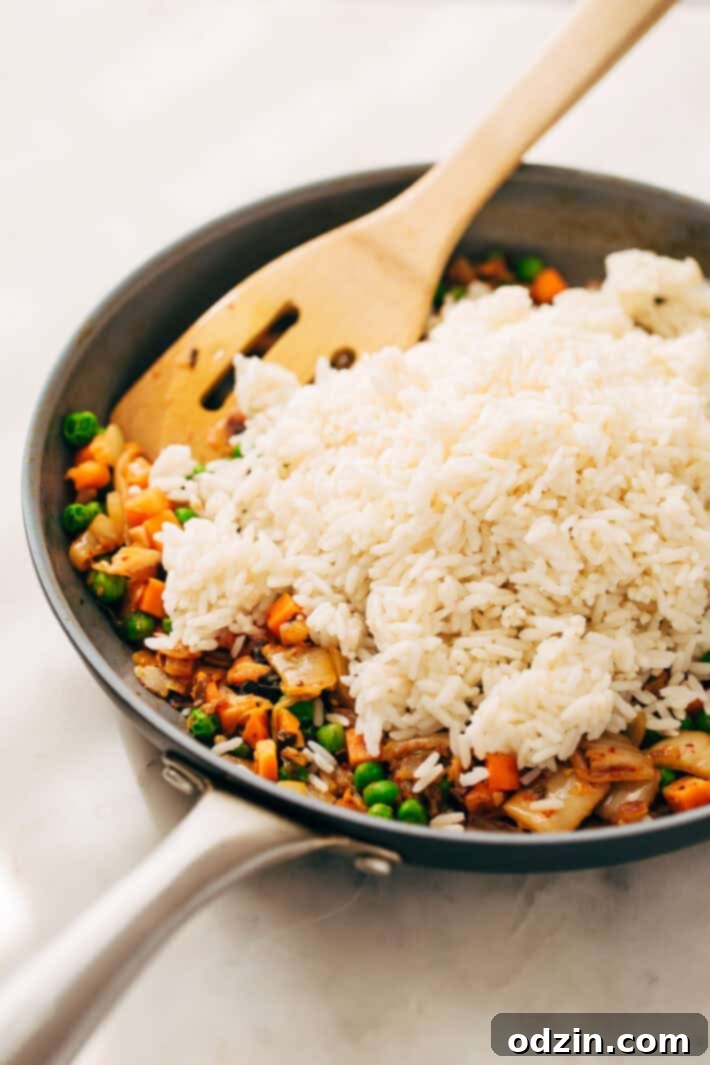 Draining Kimchi Juice for the Sauce Kimchi being pressed in a sieve to separate the juice from the cabbage.