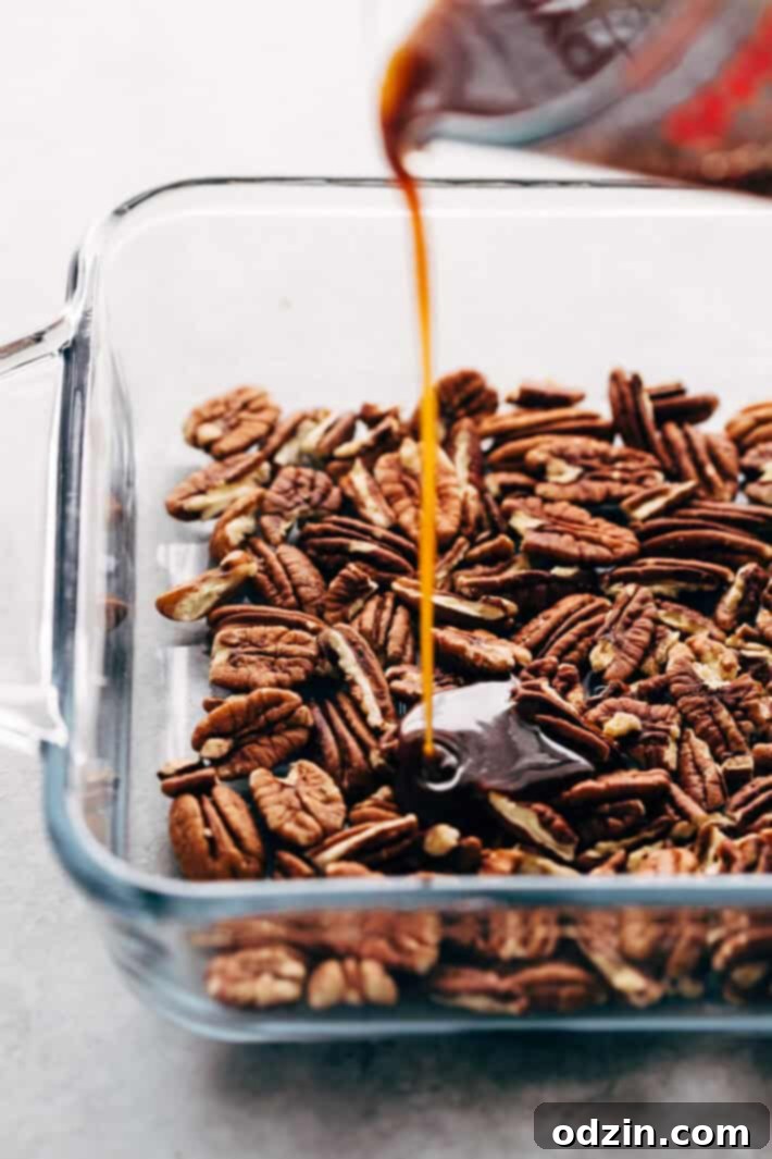 Spreading softened butter on rolled-out sticky bun dough