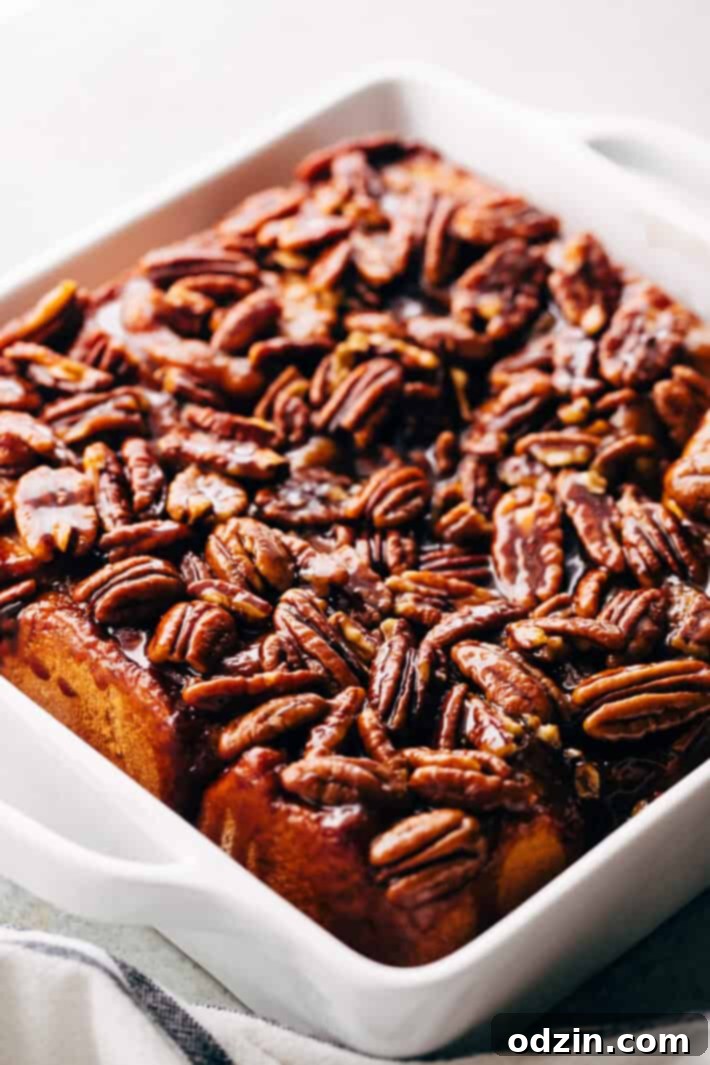 Warm caramel mixture poured over pecans in a baking dish