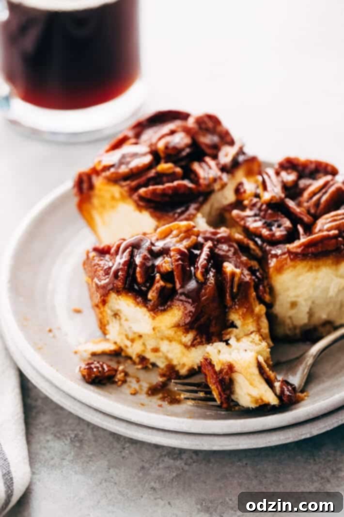 Plate of freshly baked Gooey Pecan Sticky Buns ready to serve