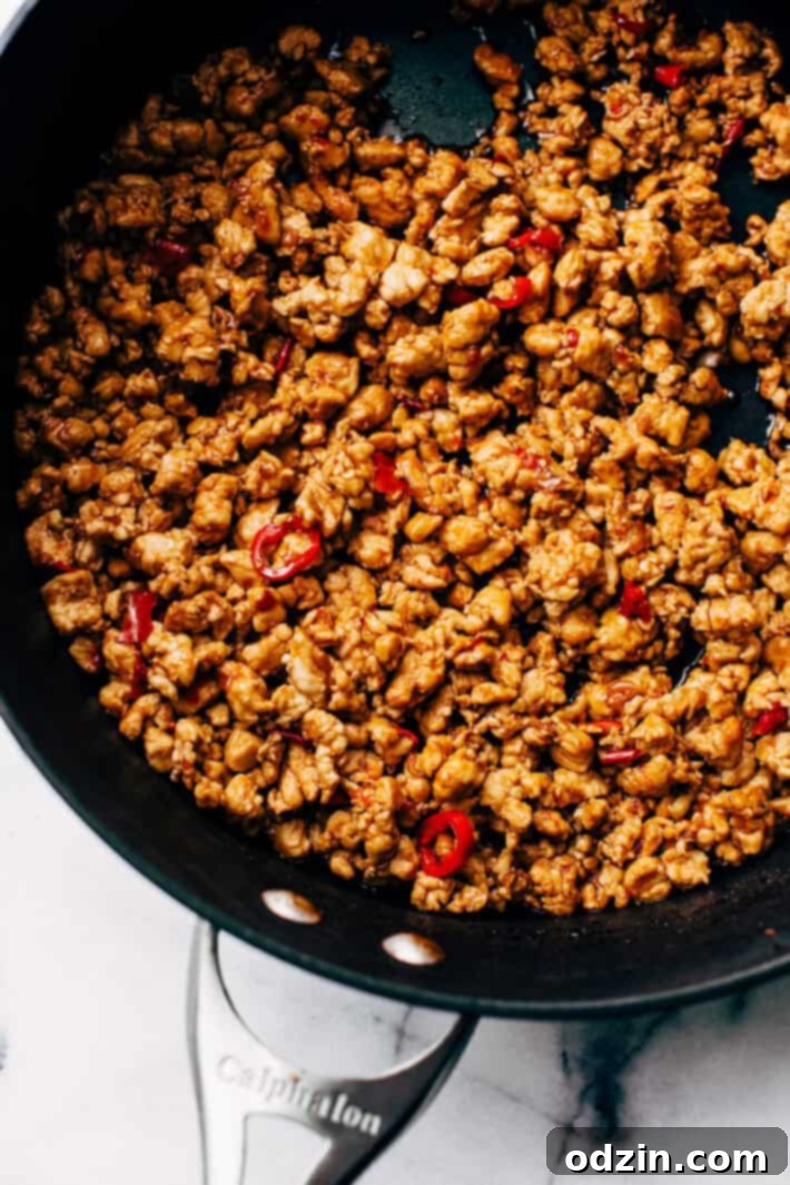 Springtime Basil Chicken Lettuce Wraps - basil chicken stuffed in lettuce wraps with garlic, red chilies, and sweet pineapple to tame that heat! The perfect protein-packed, low carb meal! #lettucewraps #thaibasilchicken #basilchicken #chickenlettucewraps | Littlespicejar.com