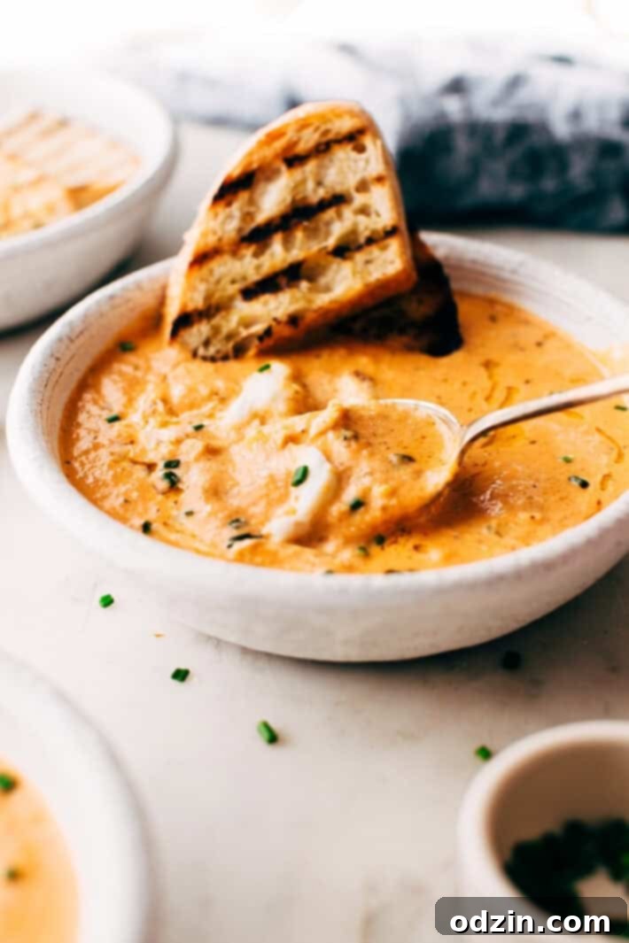 Rich and creamy Blushing Tomato Crab Bisque with fresh herbs, roasted vegetables, and a hint of spice. Served as an elegant starter or main course. #tomatocrabbisque #seafoodbisque #roastedveg