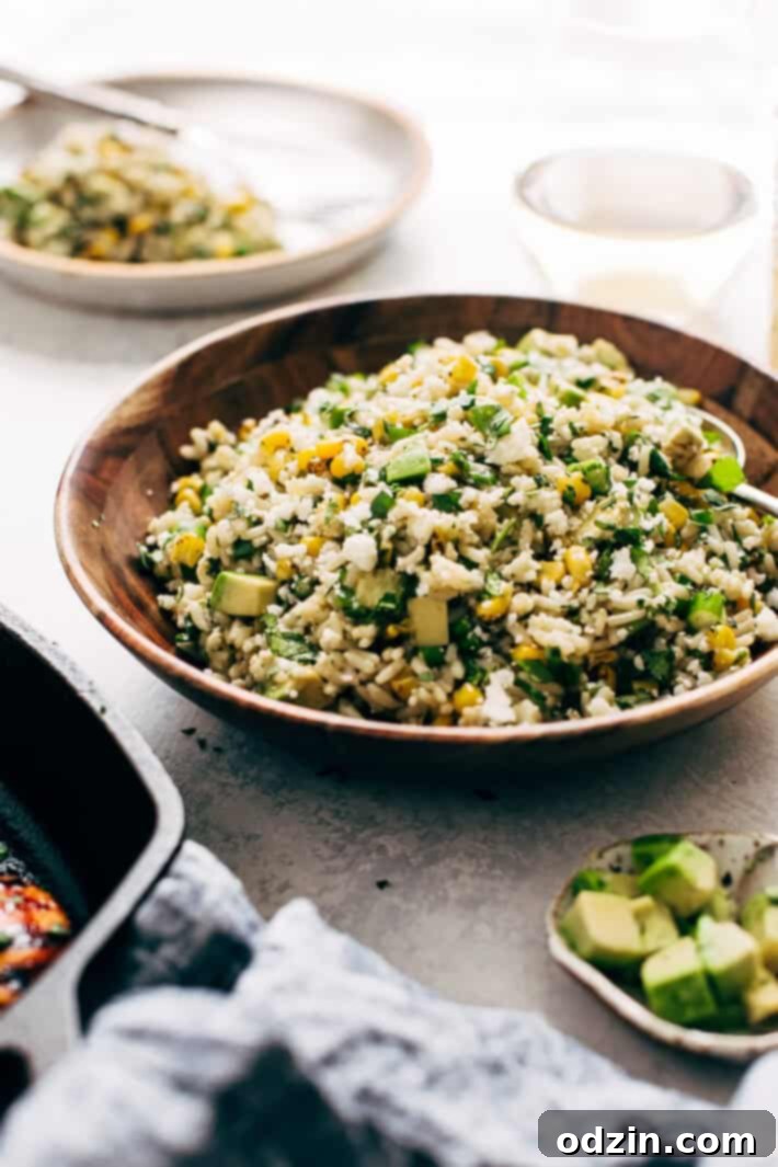 Easy Elotes Rice Salad for BBQs Vibrant Street Corn Rice Salad with avocado, scallions, and cotija cheese. Ideal for healthy summer entertaining, potlucks, and family meals. Made with an easy lemon-lime dressing.