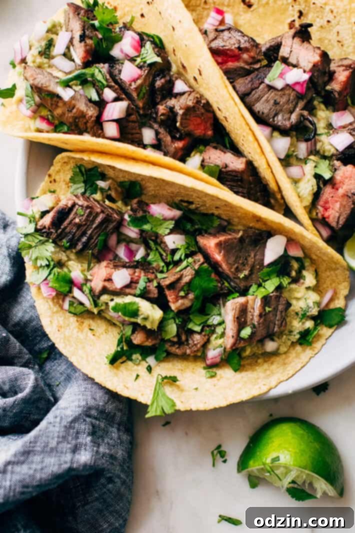 Mojo Marinated Steak cooking in a cast iron skillet, sizzling to perfection