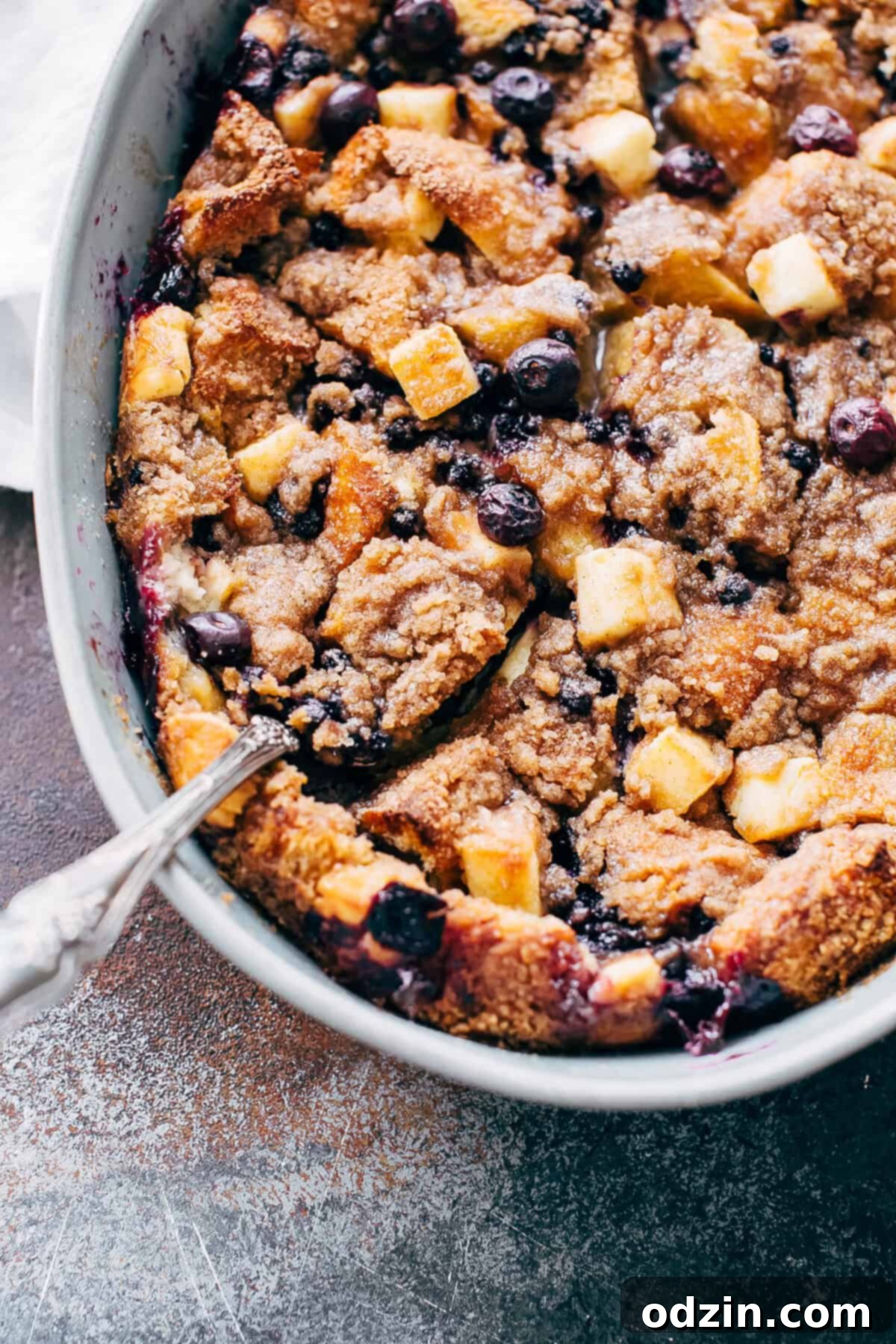 spoon scooping out blueberry French toast with cheesecake bites
